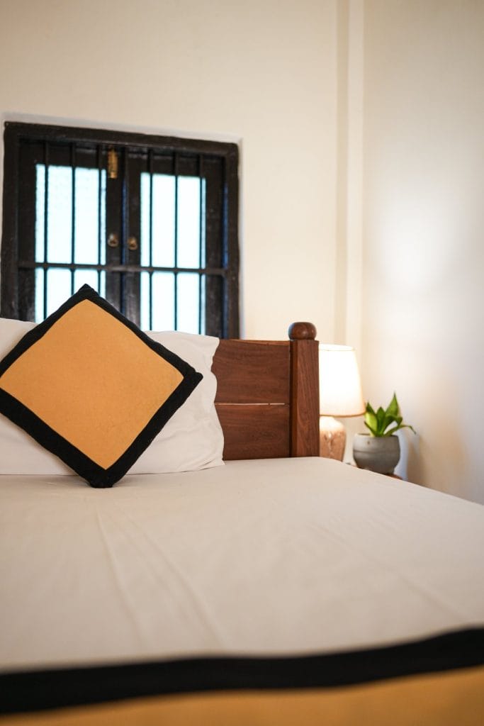 A bedroom at Medusa Bungalow, cool and high-ceilinged